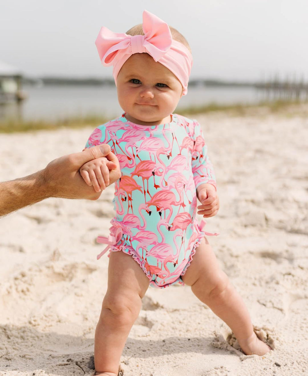 RuffleButts Baby Girls UPF 50+ Sun Protection Tropical Print Long Sleeve One Piece Rash Guard Swimsuit with Zipper - Fab Flamingo, 3-6m