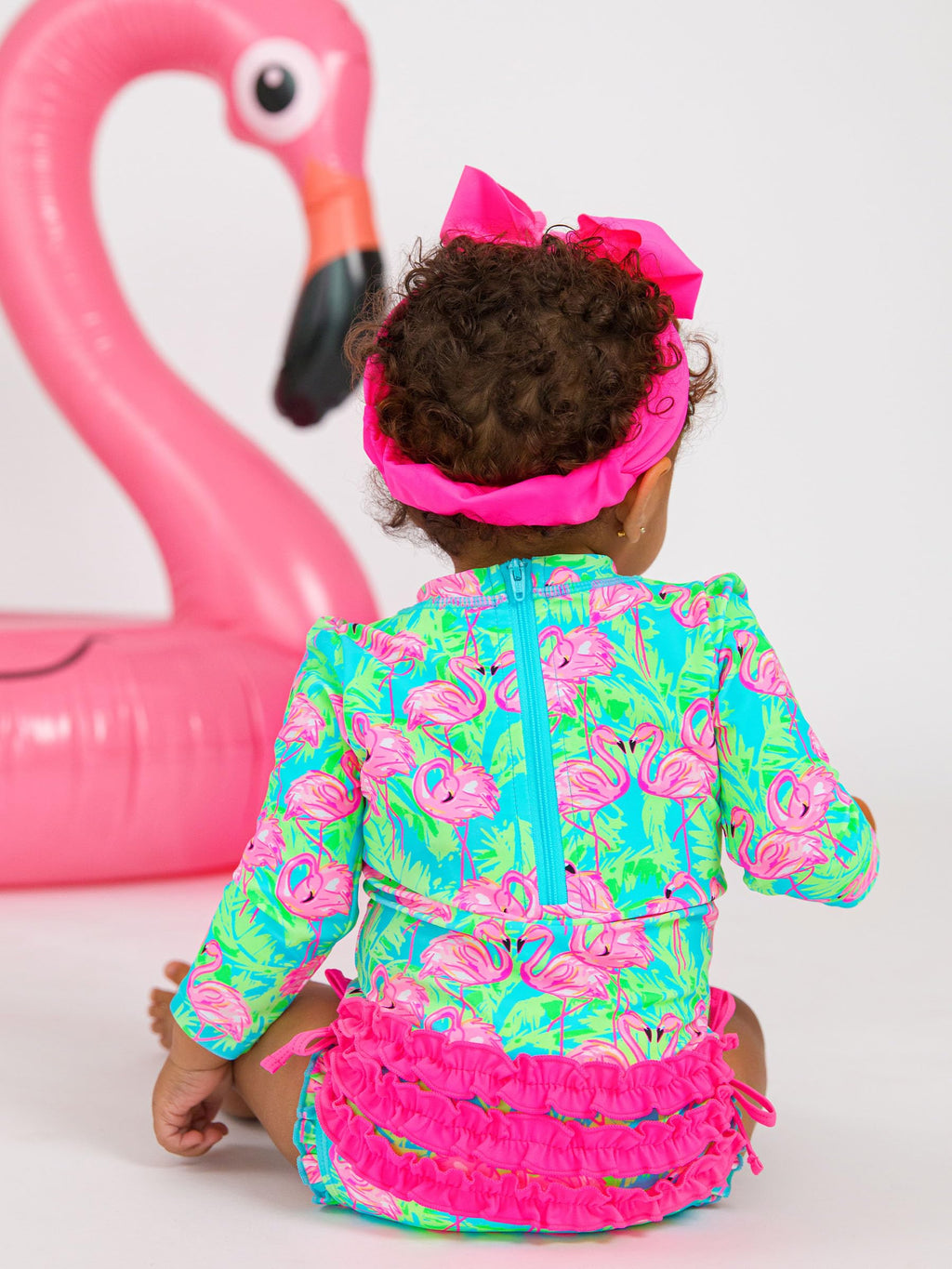 RuffleButts Baby Girls UPF 50+ Sun Protection Tropical Print Long Sleeve One Piece Rash Guard Swimsuit with Zipper - Neon Flamingo Fun, 12-18m